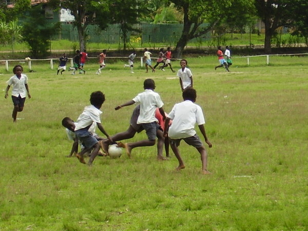 Gizo Primary school and students playing soccer