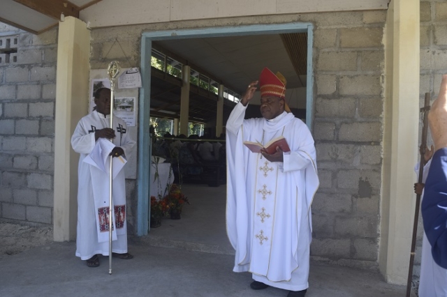 Bishop Peter make an opening prayer at the entrance of the church