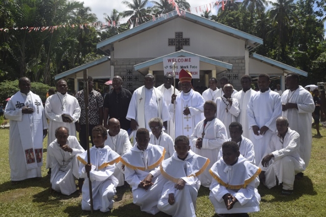 Bishop and priests pose for photo infront of the new church