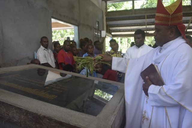 The bishop blesses the memorial stone in the church