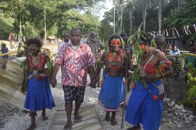 Women escorting Bishop Peter into the village